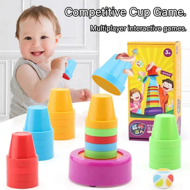 Child playing with colorful stacking cups beside a pink base and color die