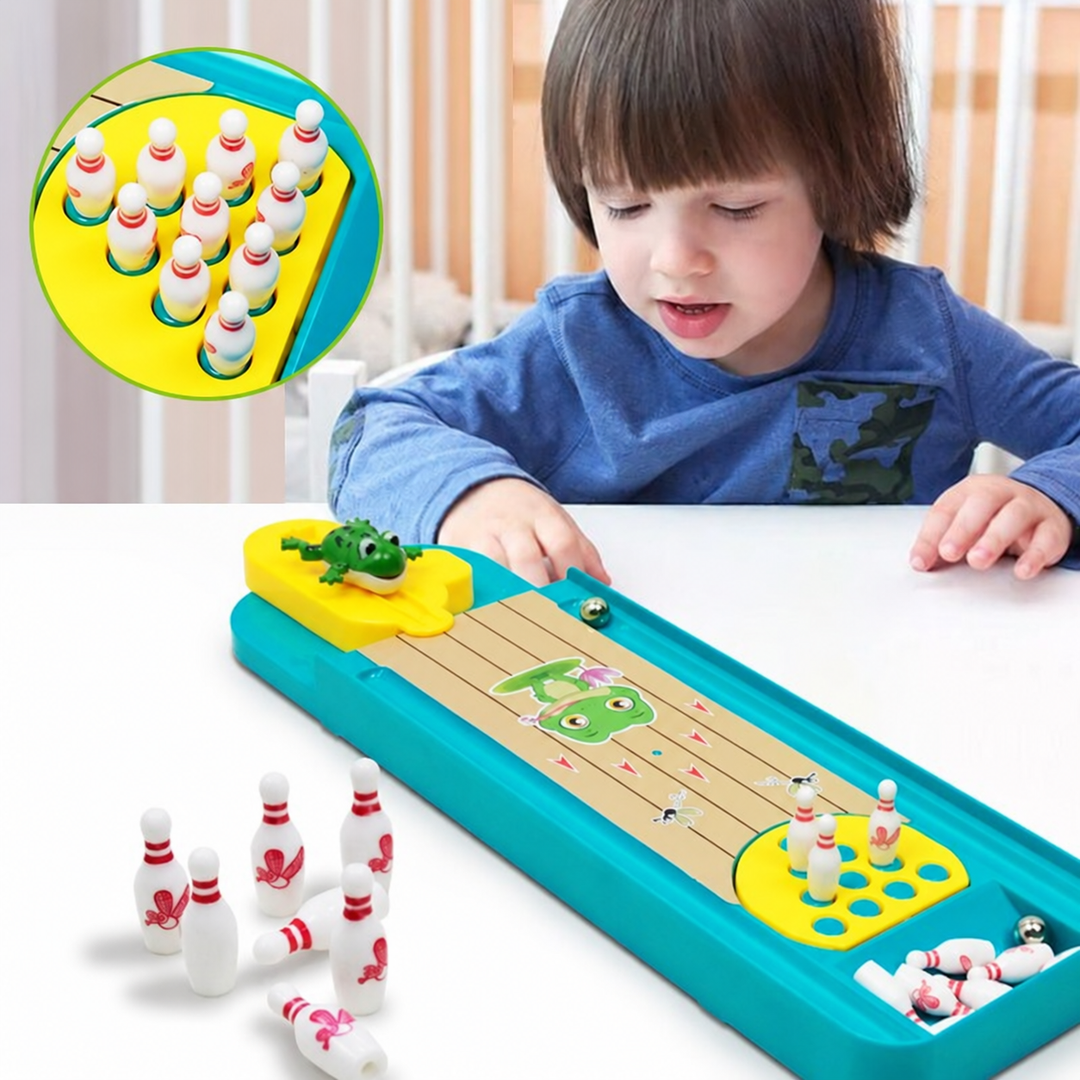 Child playing the frog-themed tabletop bowling game, with extra pins beside the lane