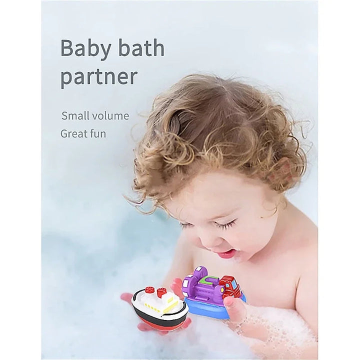 Toddler holding two colorful bath toy boats in a bubble bath