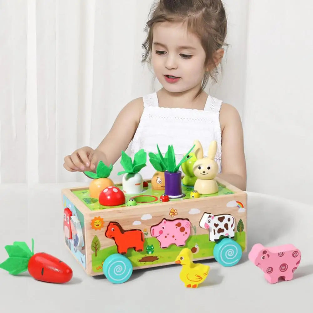 Child playing with a wooden farm wagon surrounded by animal blocks and colorful vegetable pieces