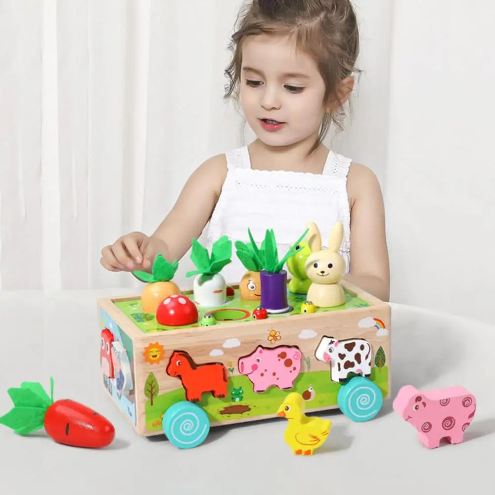 Child playing with a wooden farm wagon surrounded by animal blocks and colorful vegetable pieces