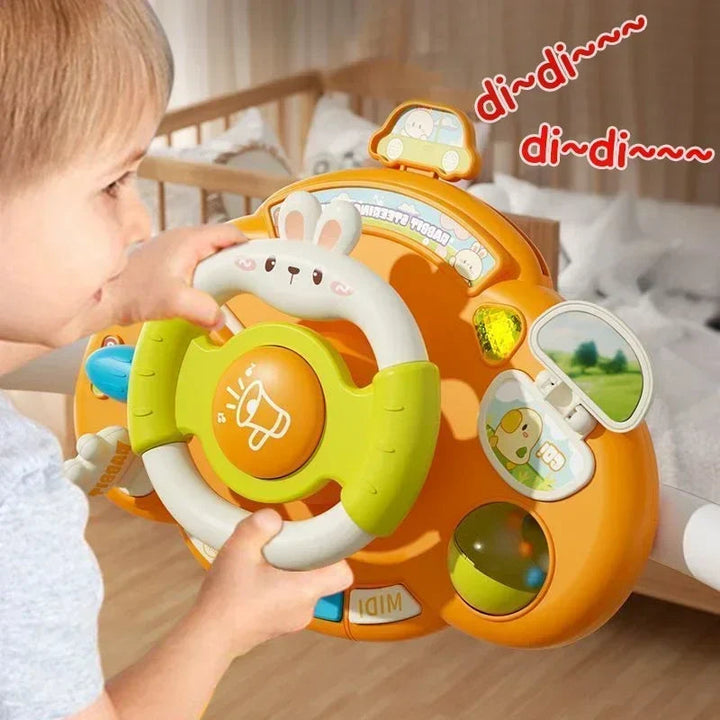 Child exploring an orange toy dashboard with a green-and-white steering wheel
