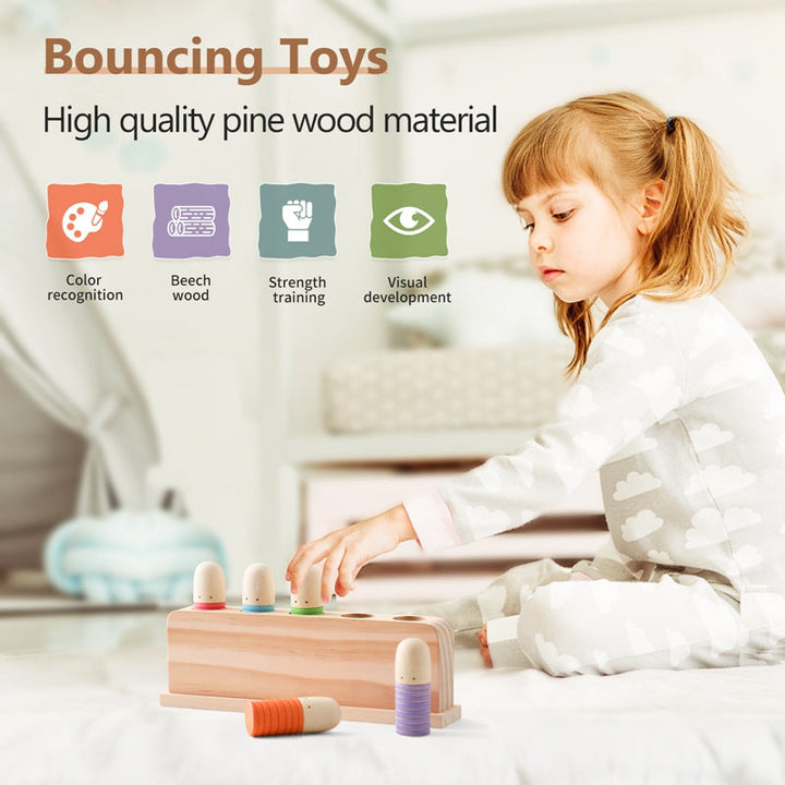 Child playing with a wooden sensory peg toy on a bed