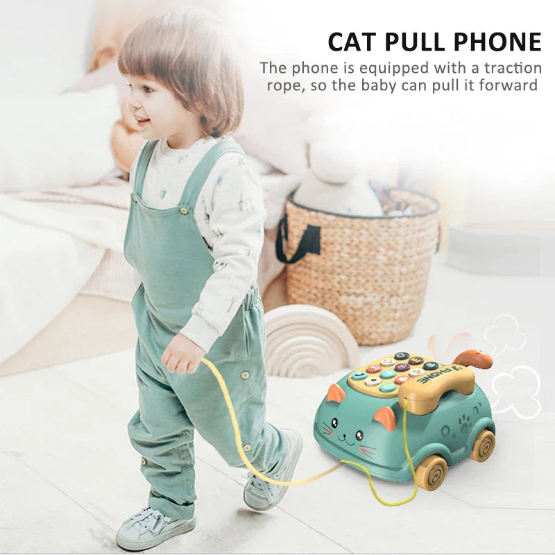 Child pulling a green cat-shaped toy phone by its cord