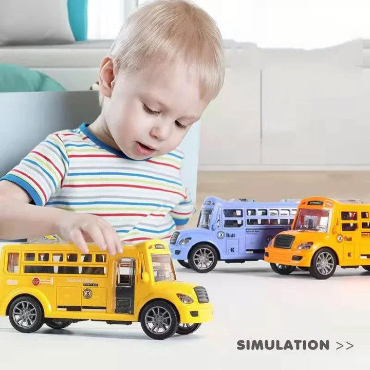 Child playing with a yellow toy bus, with two other colorful buses nearby