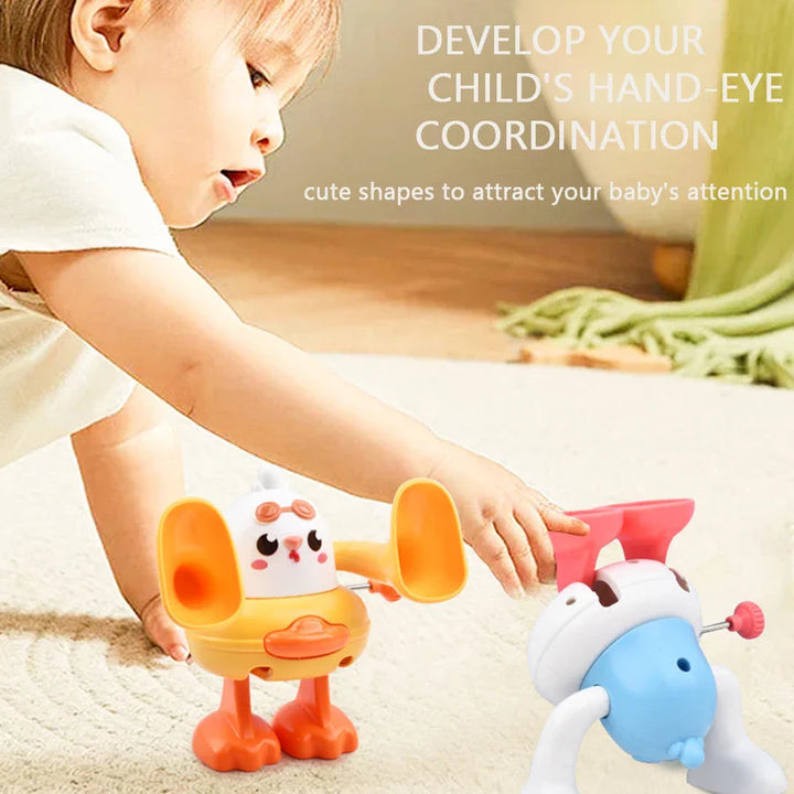 Child reaching toward an upside-down duck toy beside an upright chick toy