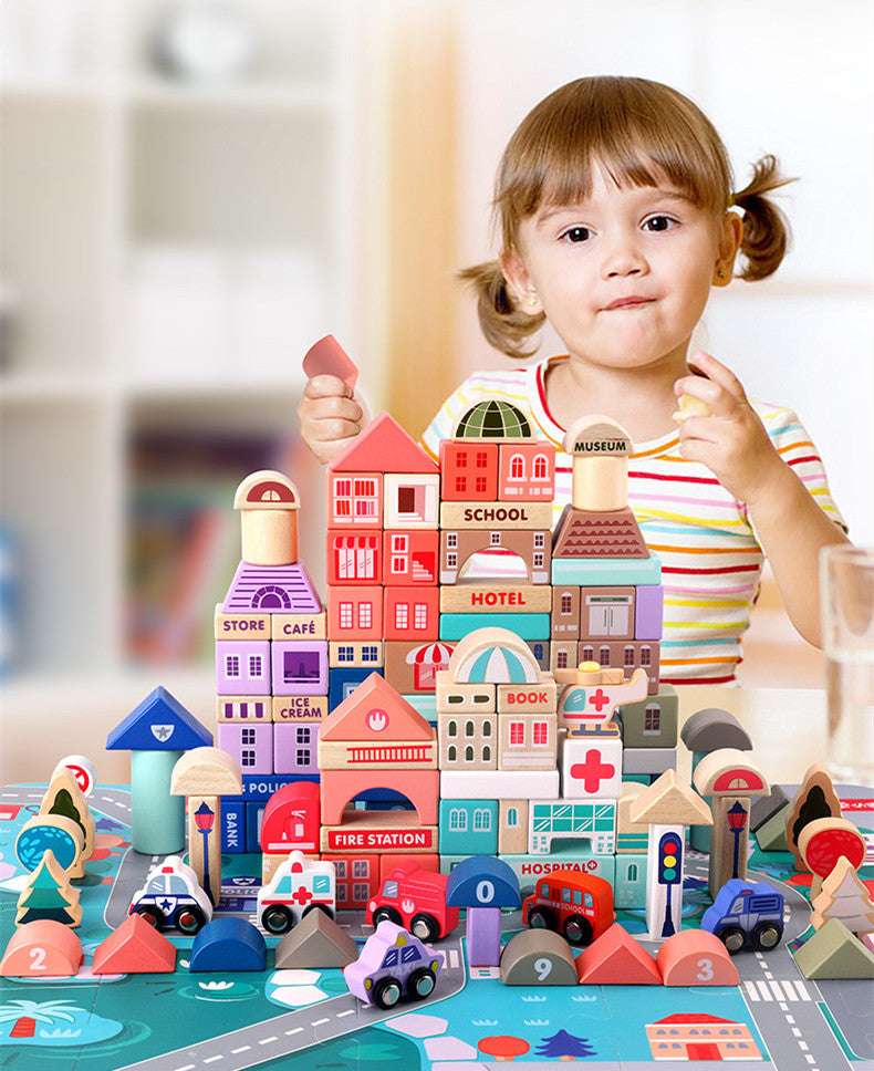 Child stacking colorful wooden city blocks on a road puzzle mat