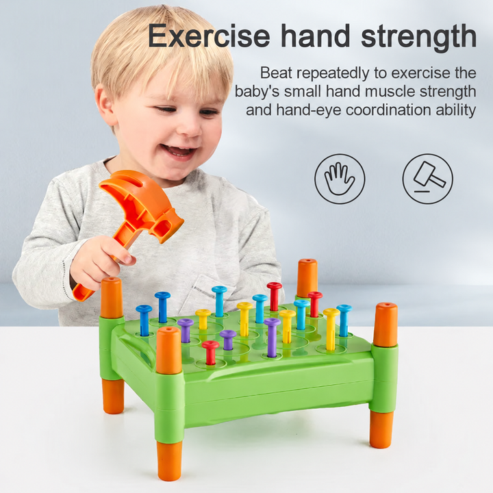 Child using an orange toy hammer to tap colorful pegs into a green board
