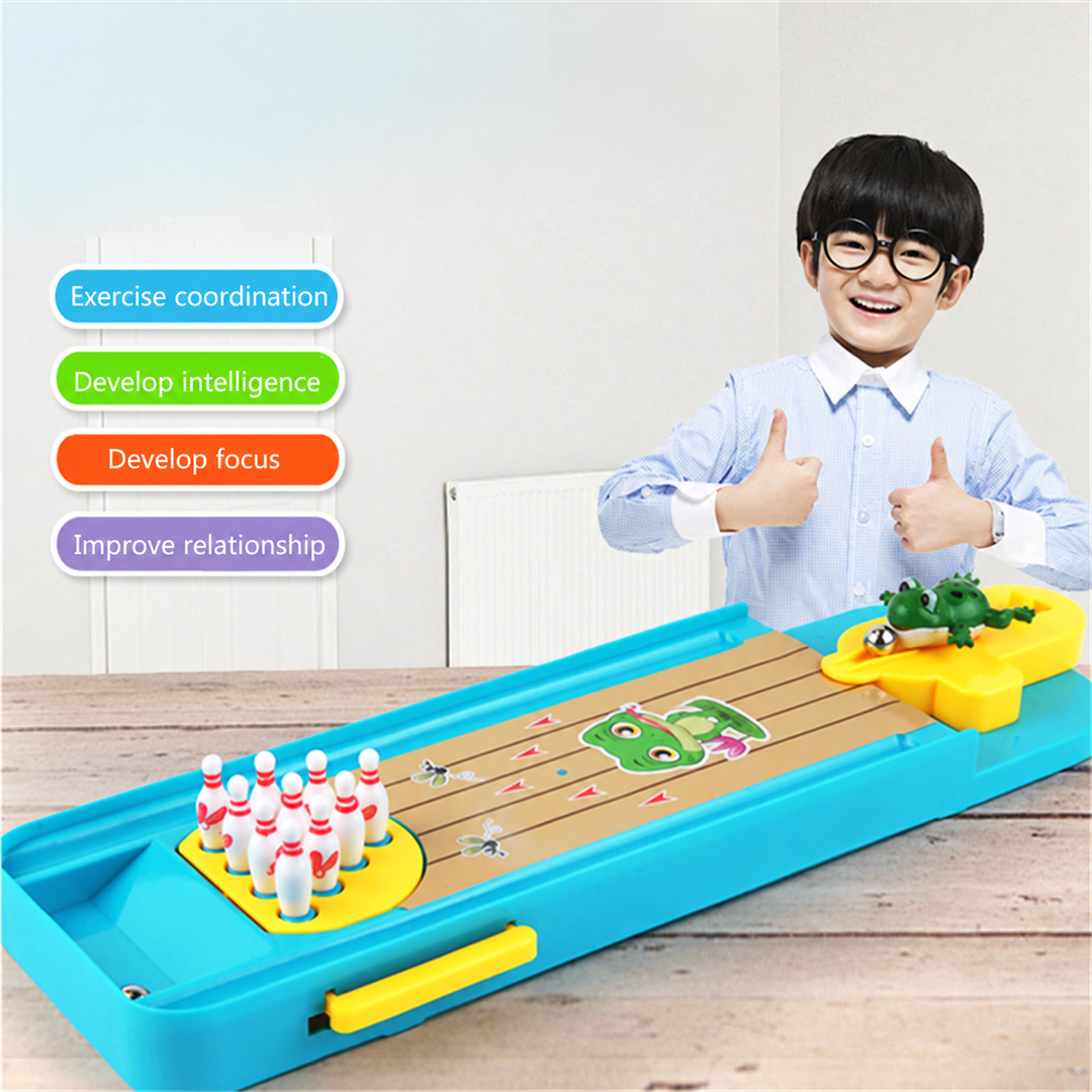 Child giving two thumbs up behind the tabletop bowling set