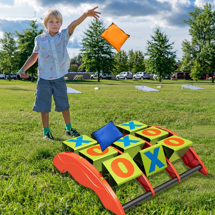 Child tossing an orange beanbag toward a rotating tic-tac-toe board outdoors