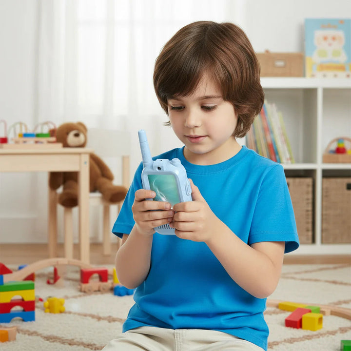 Child holding a blue handheld video intercom indoors