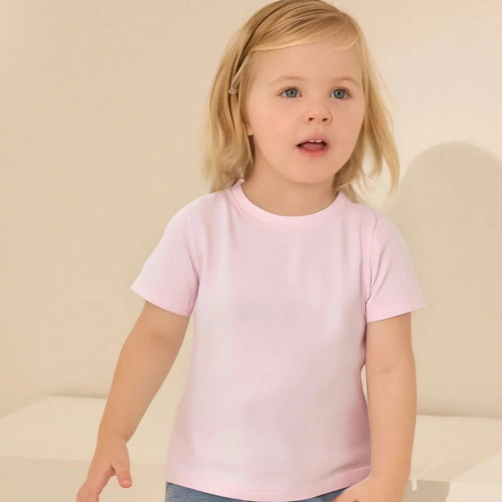 Child wearing a light pink crewneck T-shirt with short sleeves