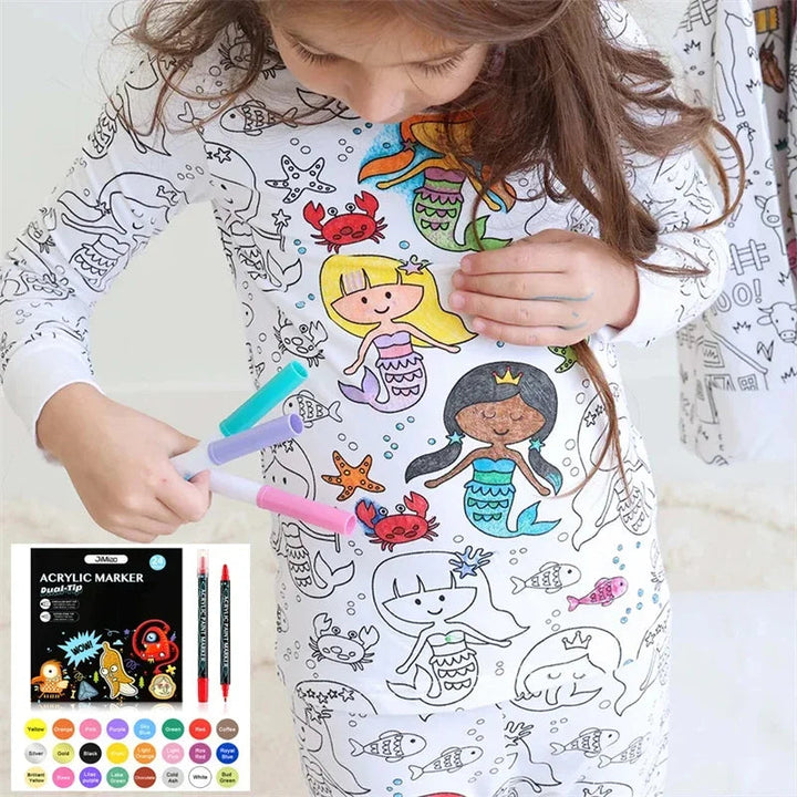 Child wearing partially colored mermaid-print pajamas and holding markers