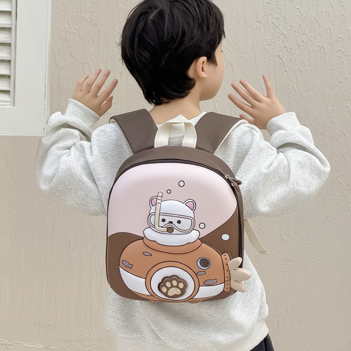 Child wearing a pink and brown animal-diver backpack with adjustable shoulder straps