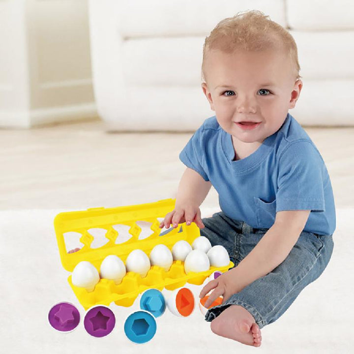 Child seated beside a yellow carton and colorful shape-matching egg halves