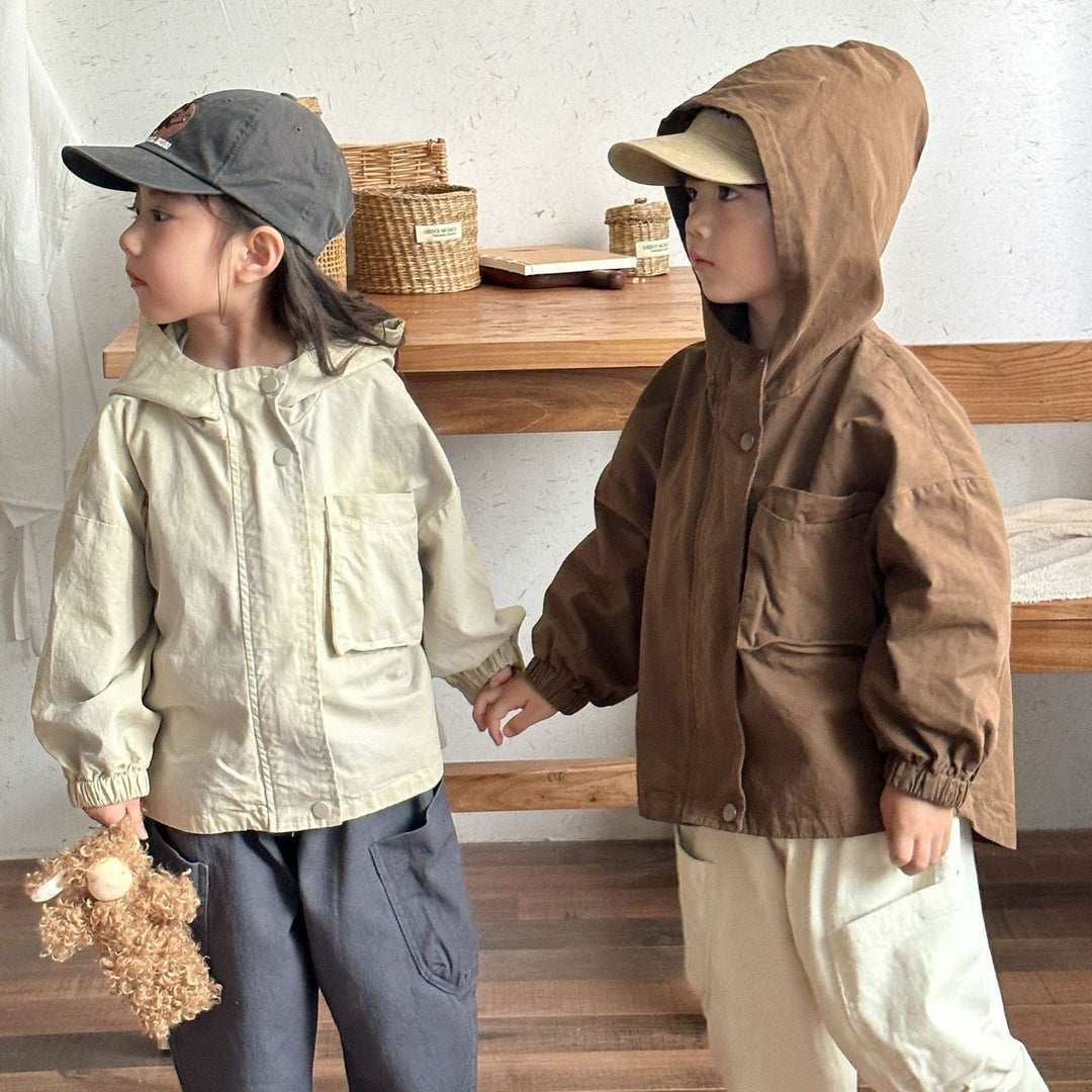 Two children wearing beige and brown hooded parkas