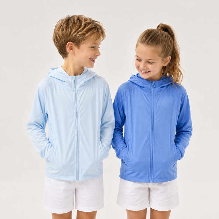 Two children wearing light blue and blue zip-up hooded jackets with white shorts.