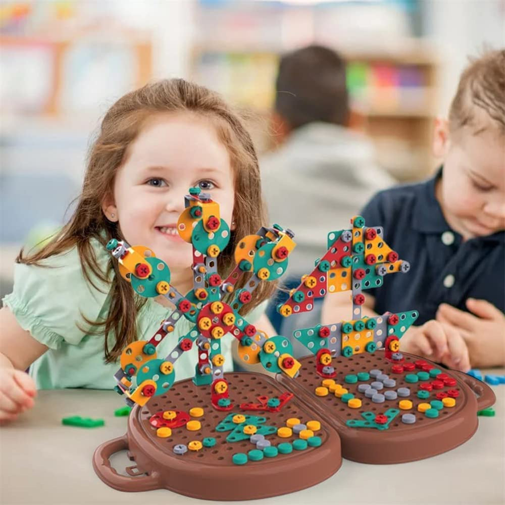 Two children with colorful upright creations on an open brown building case