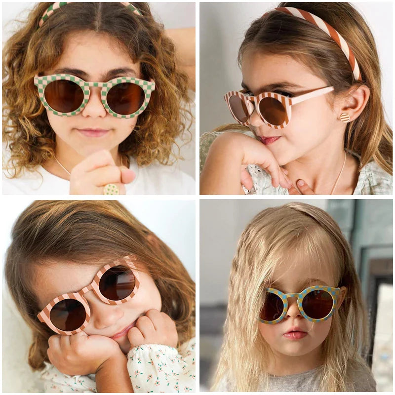 Four children wearing round sunglasses with striped and checkered frames.