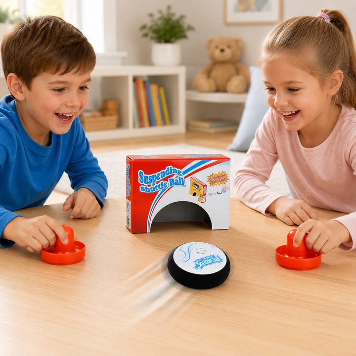 Two children playing tabletop air hockey with orange paddles and a black-and-white puck