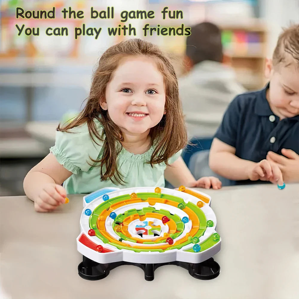 Two children sitting at a table with the colorful ball maze board.