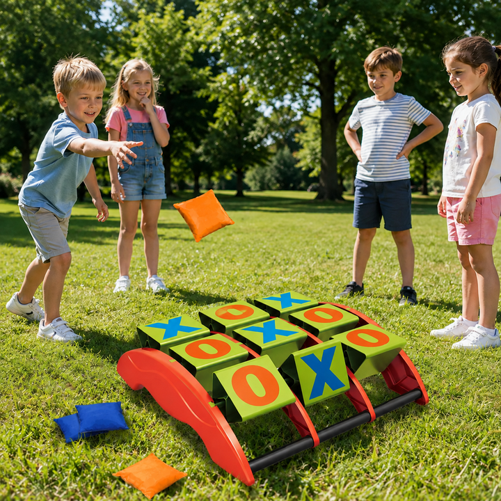 Four children playing beanbag tic-tac-toe on a lawn with orange and blue beanbags