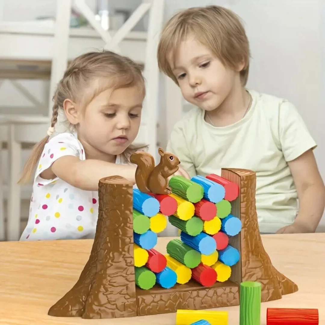 Two children playing with the squirrel balancing game at a wooden table
