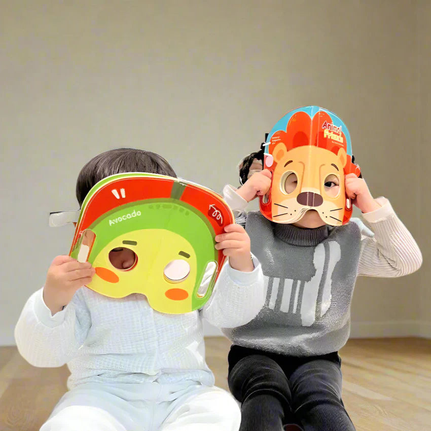 Two children holding avocado and lion cloth book pages in front of their faces.