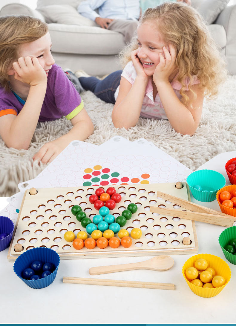 Two children playing with the wooden bead board, colorful balls, sorting cups, and tools