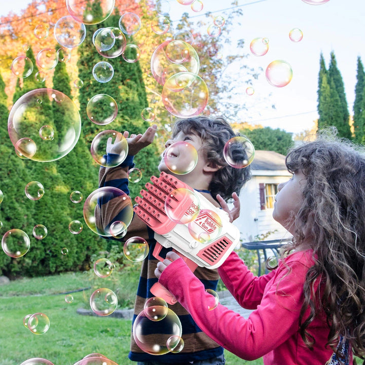 Children playing with a pink bubble gun in a garden filled with bubbles