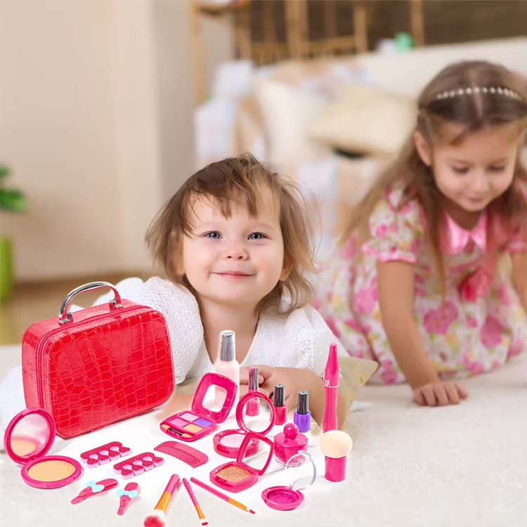 Two children with a red carry case and pink pretend makeup accessories on a table