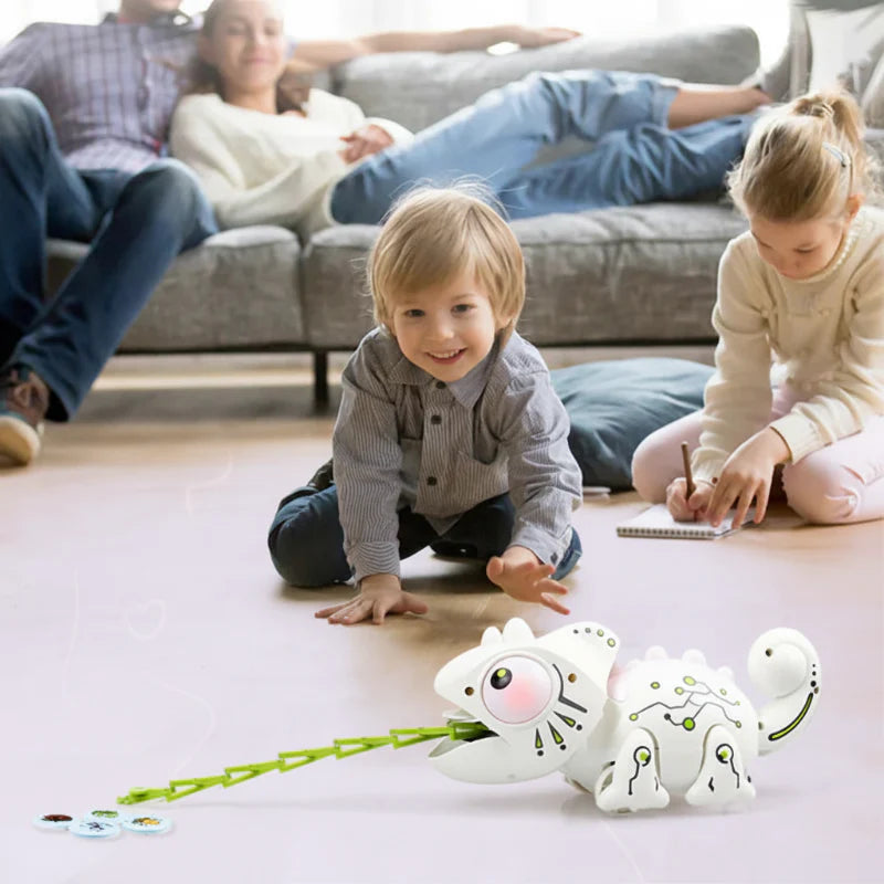 Children playing on the floor with a remote-controlled chameleon and insect-themed discs.