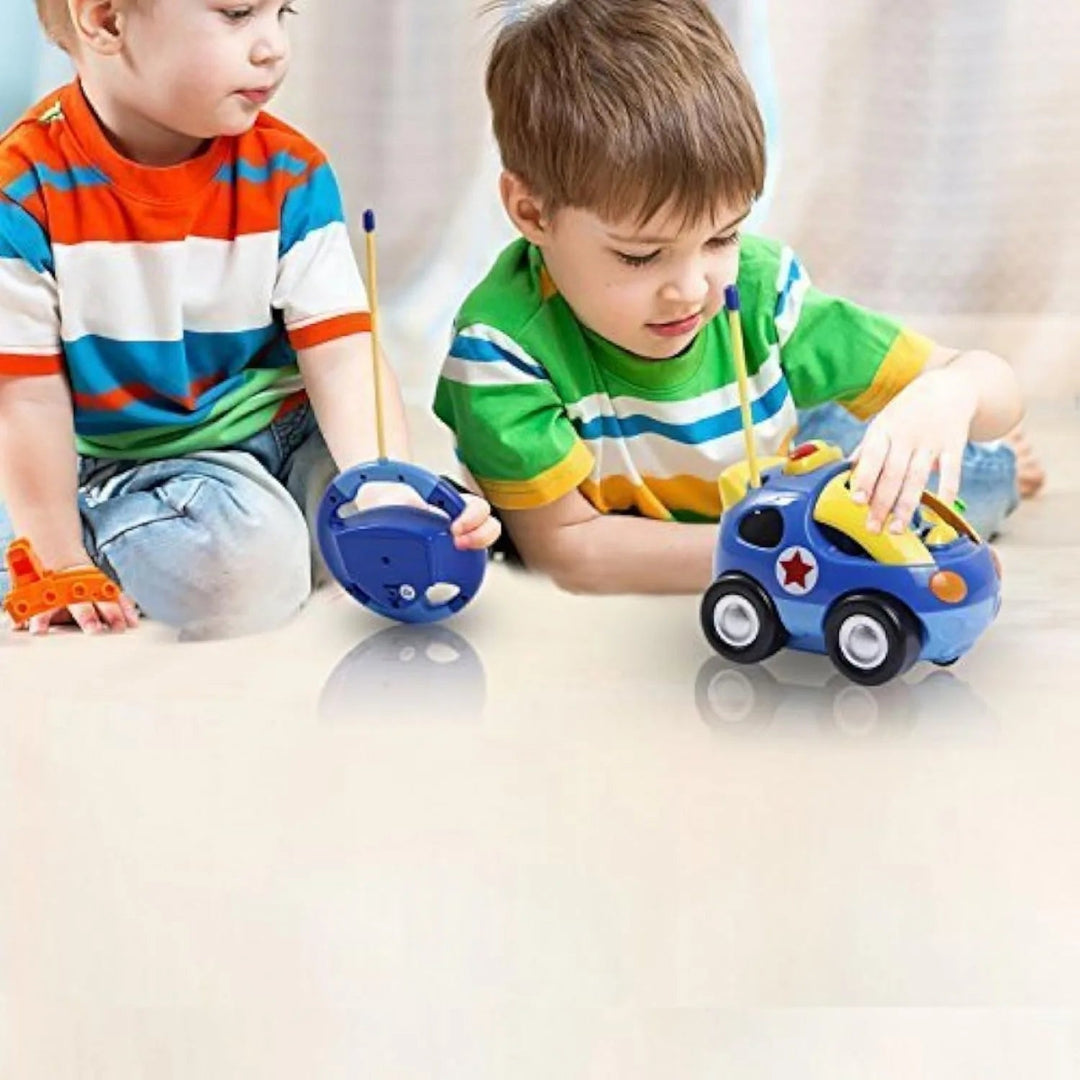 Two children playing with a police toy car and its steering-wheel-shaped remote
