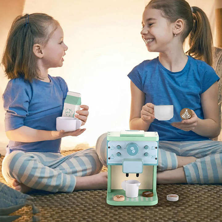 Two children playing cafe with the wooden coffee machine, toy cups and milk carton