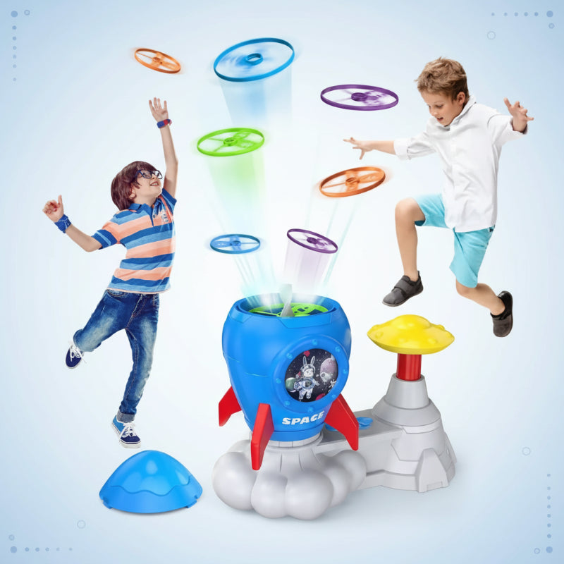 Rocket-shaped launcher shown with children reaching for colorful flying discs