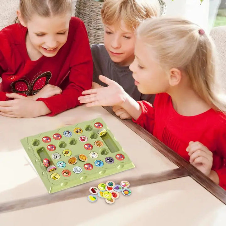 Three children gathered around the green animal memory game board and loose tokens.