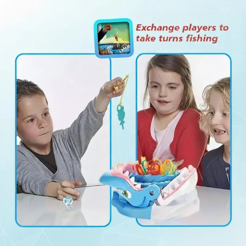 Children gather around a shark fishing game while one lifts a yellow sea creature.