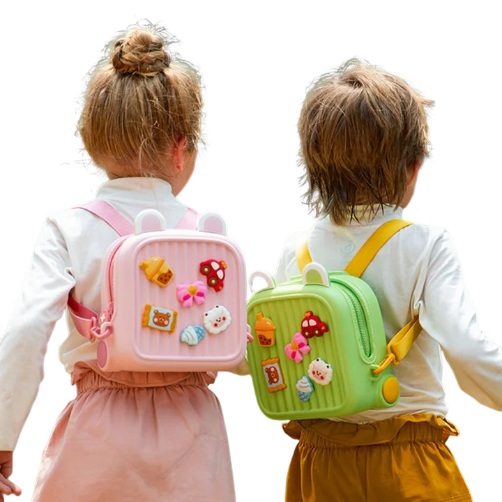 Rear view of two children wearing pink and green backpacks