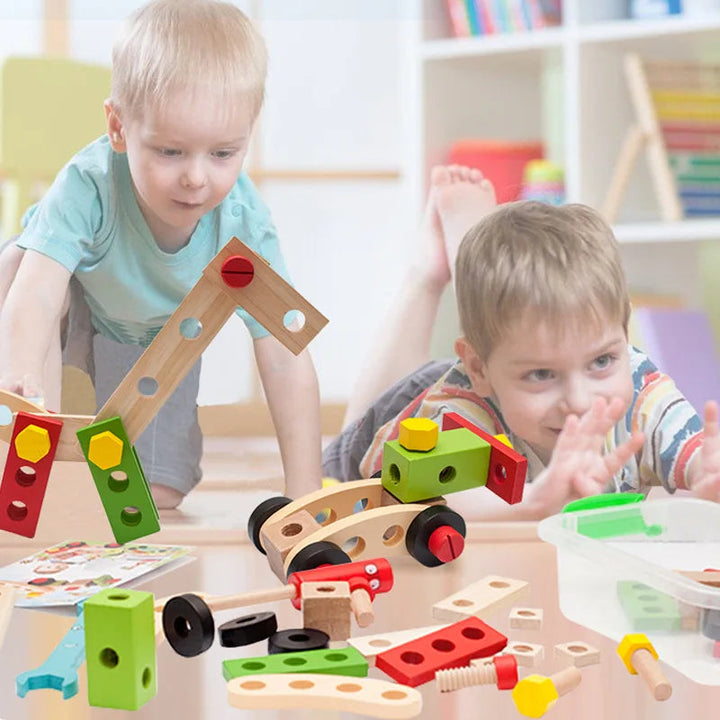 Two children playing with wooden construction models and loose building pieces at a table