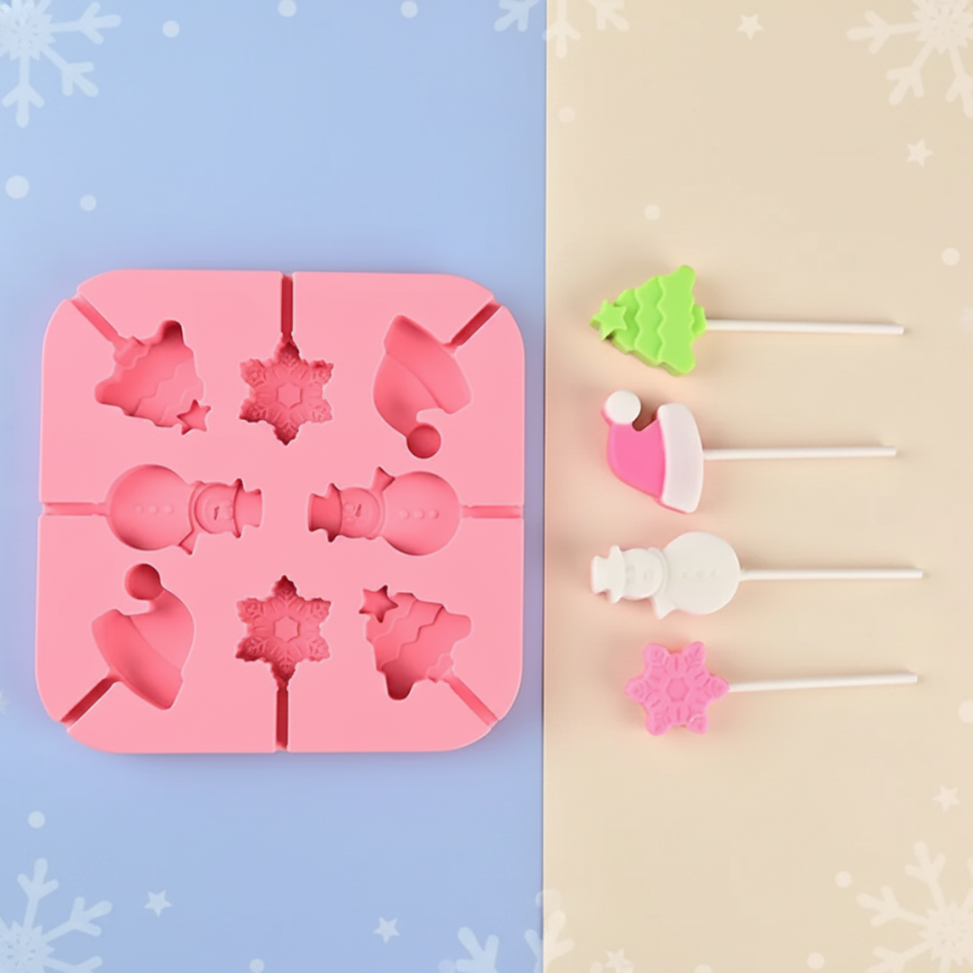Pink Christmas lollipop mold with tree, stocking, snowman, and snowflake treats