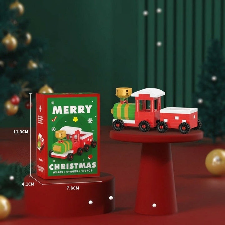 Red-and-green mini block locomotive and wagon beside their box