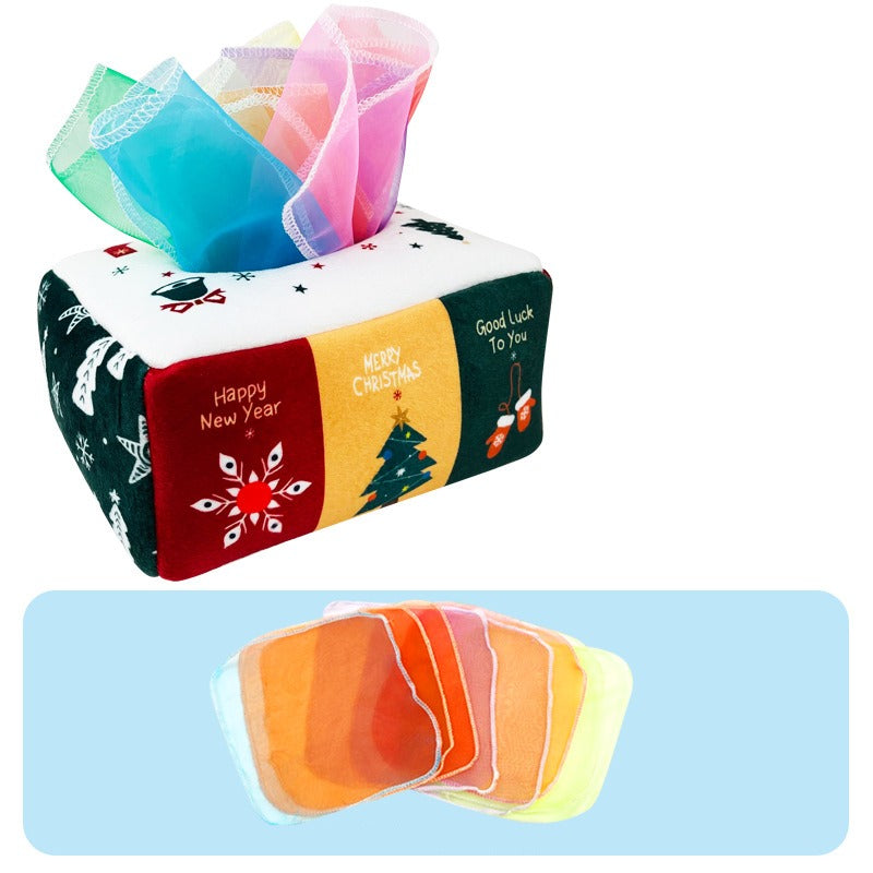 Christmas-print fabric tissue box with multicolored tissues and a row of fabric squares