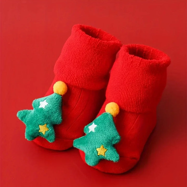 Red baby socks with green Christmas tree appliques and folded cuffs