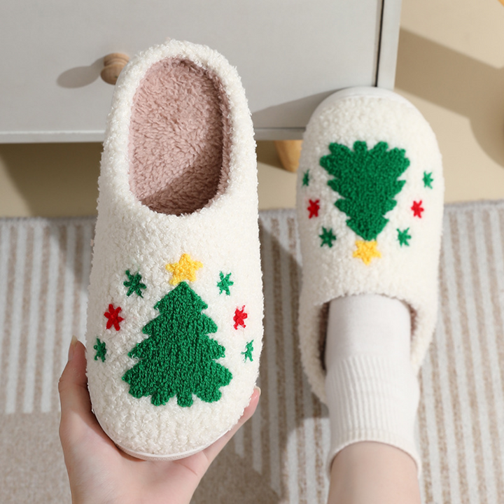 Christmas tree slippers with green trees, yellow stars and small red and green accents.