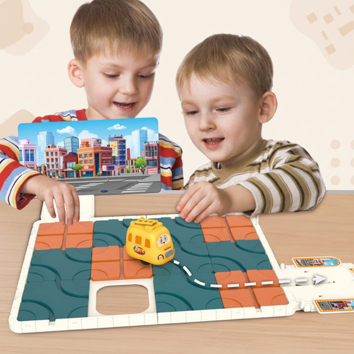 Two children arranging a sliding track puzzle with a yellow car and city backdrop