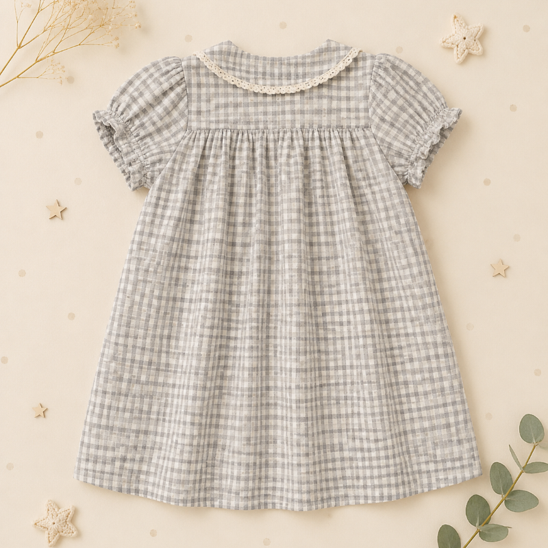 Back view of the check dress with a rounded collar, puff sleeves, and gathers below the yoke