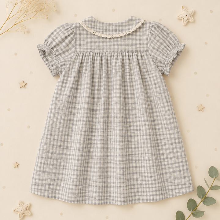 Back view of the check dress with a rounded collar, puff sleeves, and gathers below the yoke