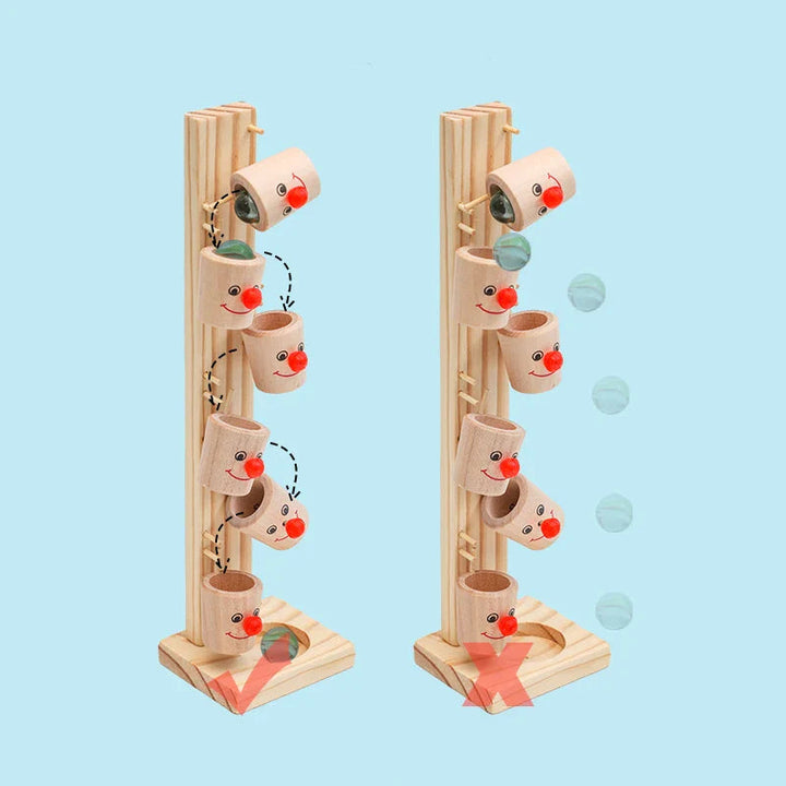 Two views of the wooden clown marble run illustrating how marbles move through the tipping cups