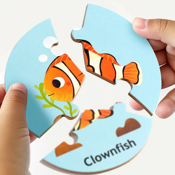 Hands holding three wooden pieces that fit together to form a clownfish puzzle