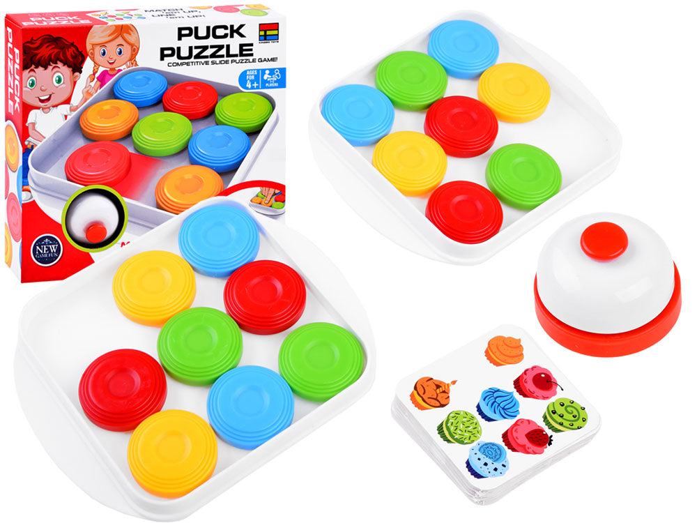 Two white sliding-puzzle boards with colorful disks, a bell, a pattern card, and the retail box